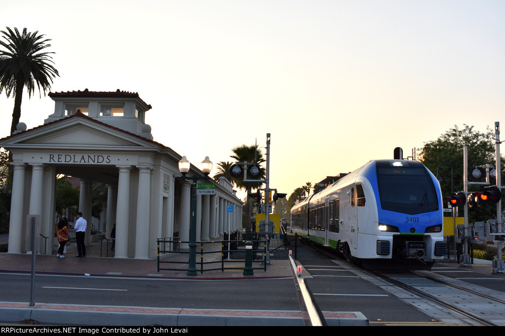 Just before twilight, an eastbound departs the Redlands-Downtown Station 